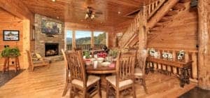 A beautiful photo of a large dining area with gas fireplace and mountain views at 2 Bedroom Cabins