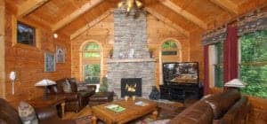 An inviting living room with stone fireplace in Gatlinburg Cabins
