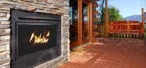 A beautiful fireplace and swing on the deck of one of Pigeon Forge Cabins