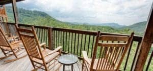 Rocking chairs on the deck overlooking a mountain view of Sevierville Cabins