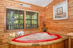 heart shaped jacuzzi inside romancing the stars cabin