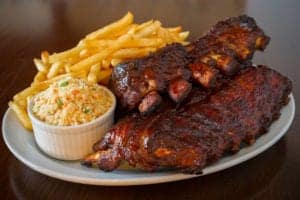 plate of bbq ribs, fries, and coleslaw