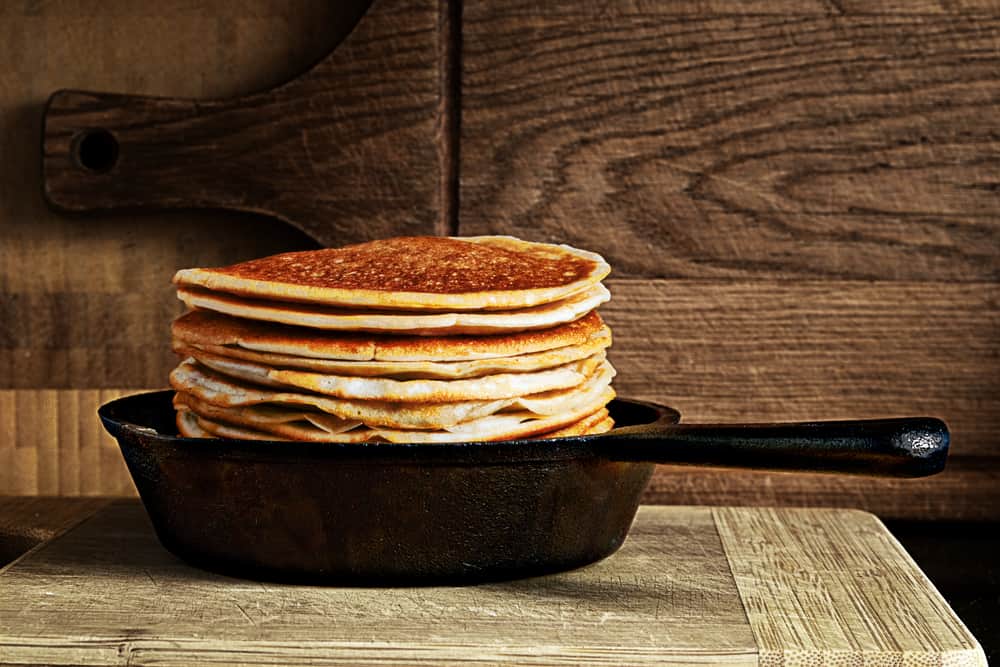 stack of pancakes in a cast iron skillet