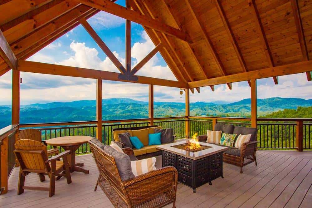 deck with a fire pit and a mountain view